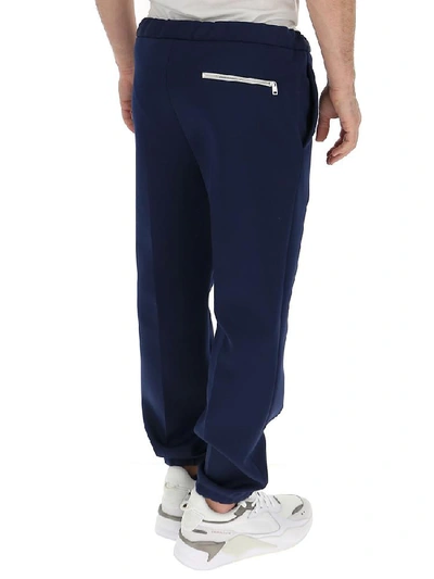 Shop Prada Logo Zip Pocket Trousers In Blue