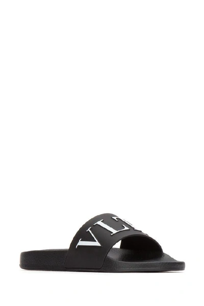 Shop Valentino Vltn Rubber Slide Sandals In Black