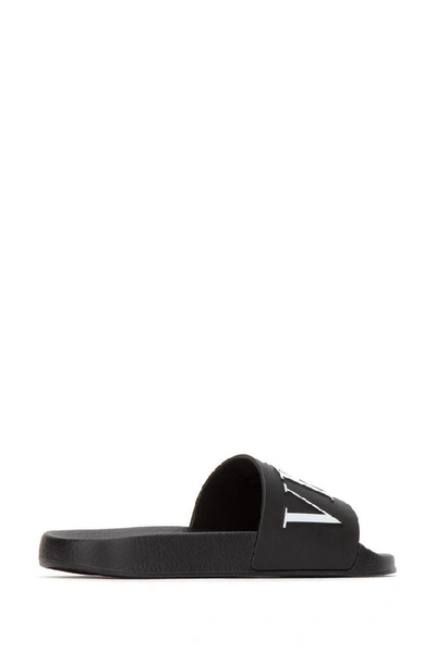 Shop Valentino Vltn Rubber Slide Sandals In Black