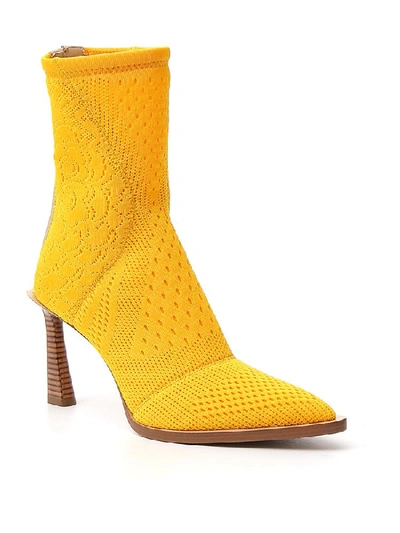 Shop Fendi Tronchetto Pointed Toe Ankle Boots In Yellow