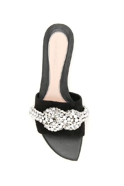 Shop Alexander Mcqueen Crystal Embellished Knot Mules In Black