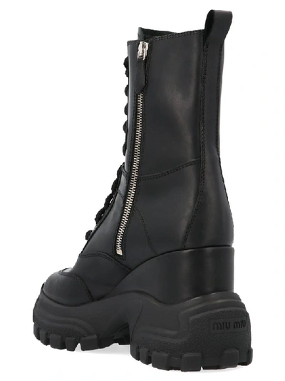 Shop Miu Miu Zipped Chunky Sole Ankle Boots In Black