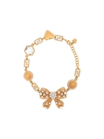 Shop Versace Crystal Embellished Bow Charm Choker In Gold