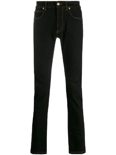 Shop Versace Embroidered Safety Pin Jeans In Black