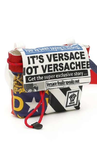 Shop Versace Printed Drawstring Crossbody Bag In Multi