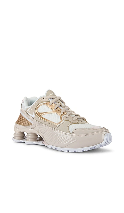 Shop Nike Shox Enigma Sneaker In Desert Sand, White Summit & Soft Pink