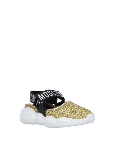 Shop Moschino Sneakers In Gold