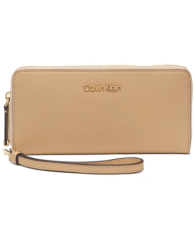 Shop Calvin Klein Saffiano Leather Zip-around Wallet In Rye/gold