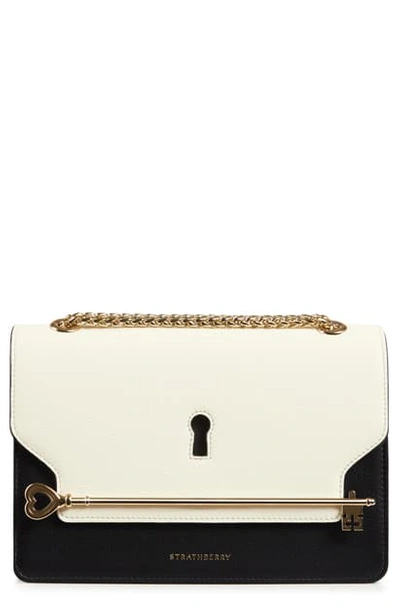 Shop Strathberry East/west Keyhole Leather Crossbody Bag In Vanilla/ Black