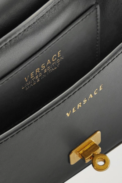 Shop Versace Embellished Printed Leather Shoulder Bag In Black