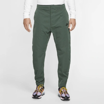 Shop Nike Sportswear Men's Woven Pants In Green