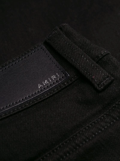 Shop Amiri Ripped Slim-fit Jeans In Black