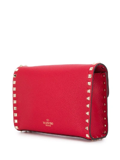 Shop Valentino Small Rockstud Crossbody Bag In Red