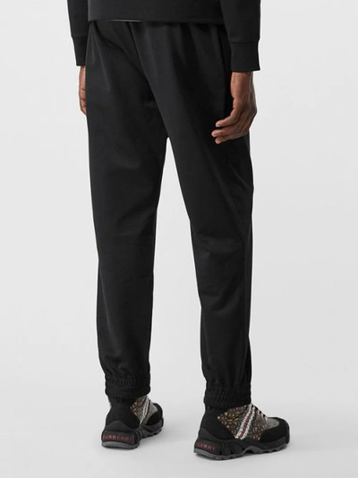 Shop Burberry Logo Graphic Jersey Trackpants In Black