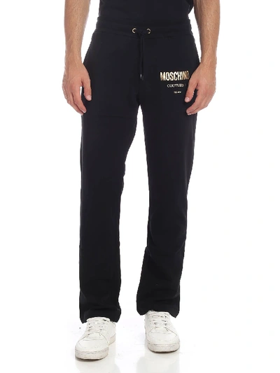 Shop Moschino Black Trousers With Logo Print