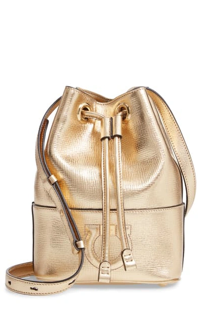 Shop Ferragamo City Quilted Gancio Bucket Bag - Metallic In Gold Metallic Leather