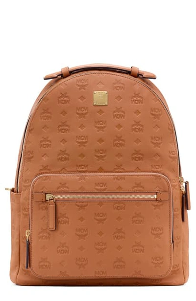 Shop Mcm Stark Monogram Embossed Leather Backpack In Cognac
