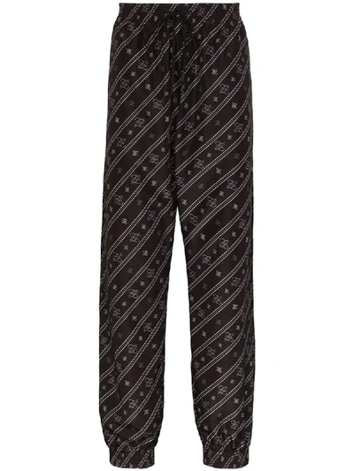 Shop Fendi Karligraphy Logo-print Shell Sweatpants In Black