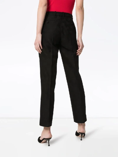 Shop Gucci Gg-embroidered Wool And Silk-blend Slim-fit Trousers In Black