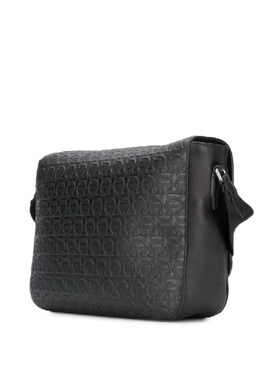 Shop Ferragamo Embossed Gancini Messenger Bag In Black