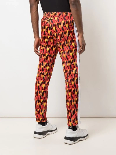 Shop Palm Angels Flame Print Track Pants In Red
