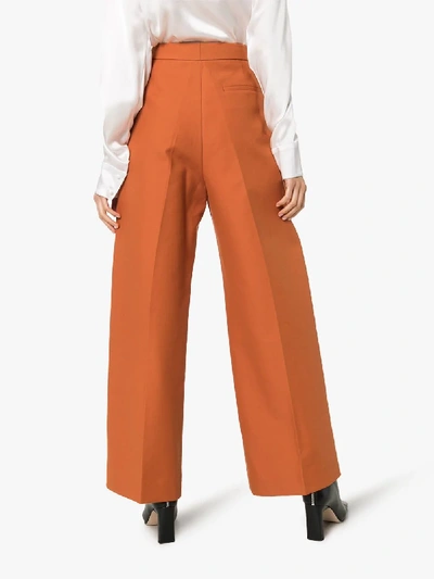Shop Khaite Yasmin Wide Leg Trousers In Orange