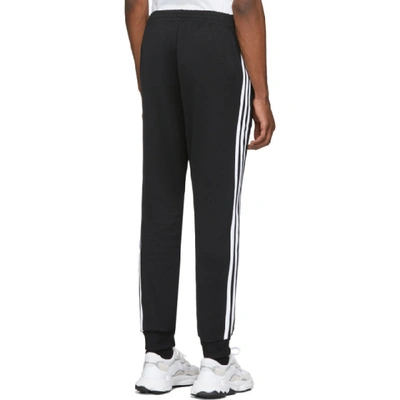 Shop Adidas Originals Black Sst Track Pants