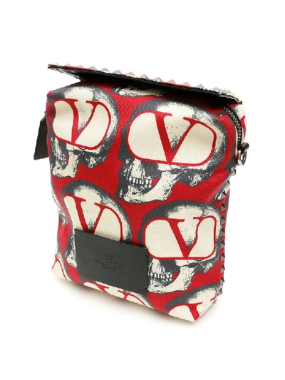 Shop Valentino Undercover Skull Messenger Bag In Rouge Pur Nero (white)
