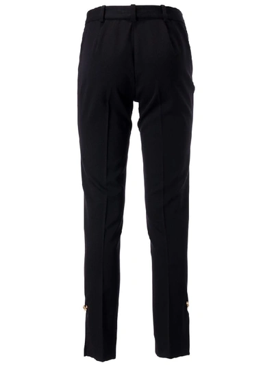 Shop Versace Button Embellished Trousers In Black