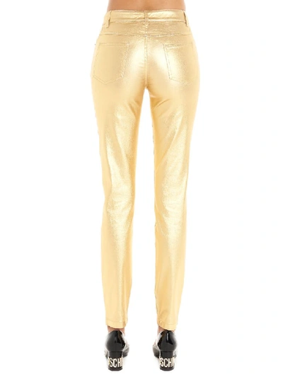 Shop Moschino Pants In Gold