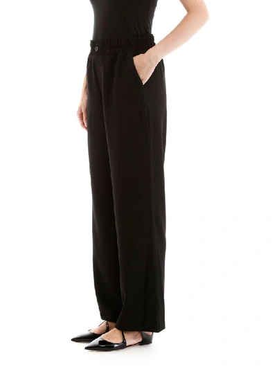 Shop Ganni Crepe Trousers In Black (black)