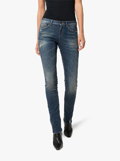 Shop Saint Laurent Low-rise Flared Jeans In Blue
