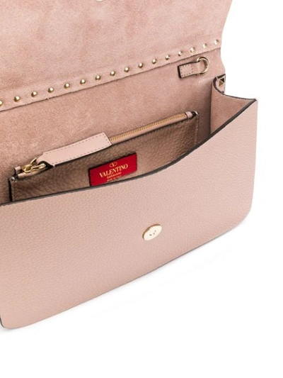 Shop Valentino Rockstud Clutch Bag In Neutrals