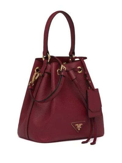 Shop Prada Saffiano Bucket Bag In Red