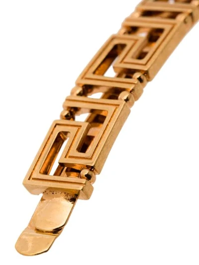 Shop Versace Greek Key Brooch In Gold