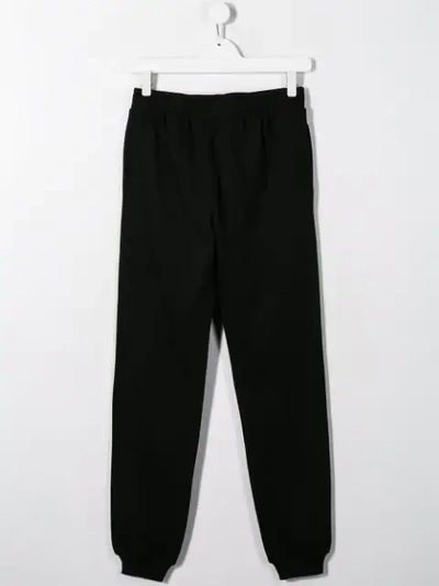 Shop Moschino Teen Logo Track Pants In Black