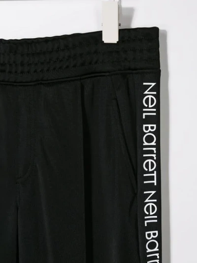 Shop Neil Barrett Logo Tape Track Pants In Black