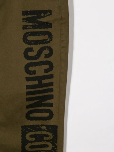 Shop Moschino Logo Print Trousers In Green