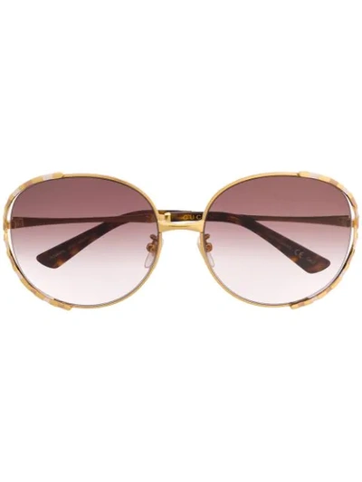 Shop Gucci Striped Frame Sunglasses In Gold