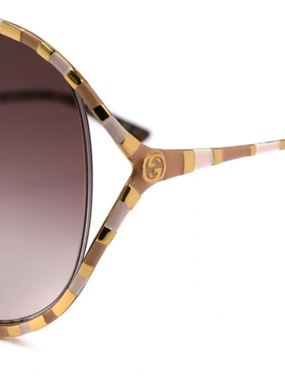 Shop Gucci Striped Frame Sunglasses In Gold