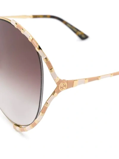 Shop Gucci Striped Detail Sunglasses In Gold