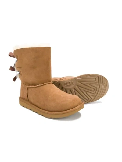 Shop Ugg Teen Bow Shearling Boots In Brown