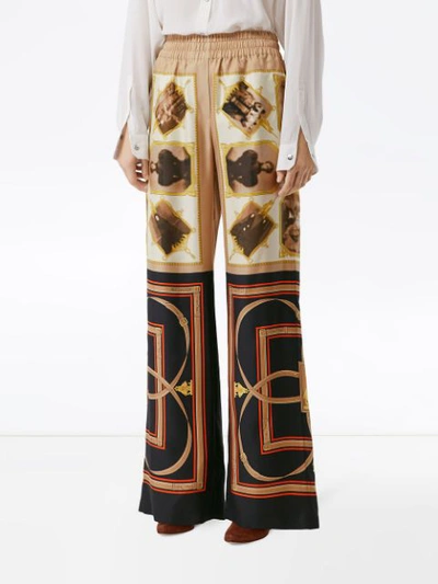 Shop Burberry Montage Print Flared Trousers In Brown