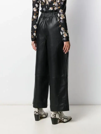 Shop Ganni Wide-leg Leather Trousers In Black