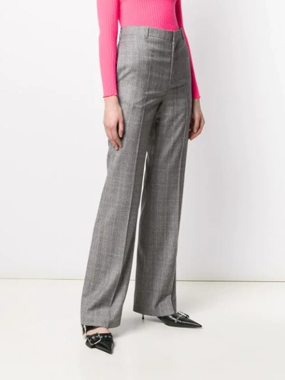 Shop Balenciaga Flared Checked Trousers In Black