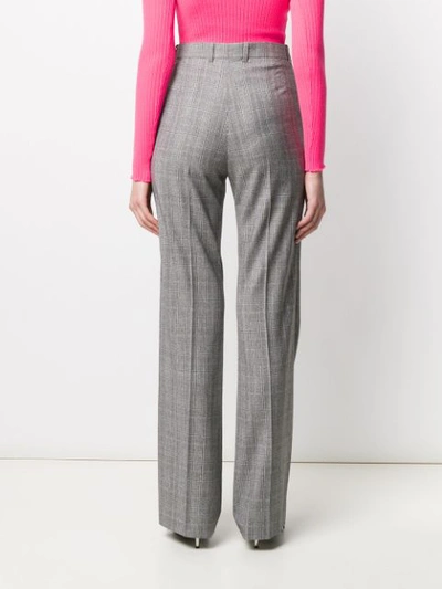 Shop Balenciaga Flared Checked Trousers In Black