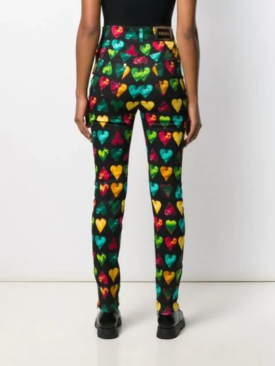 Shop Versace Heart Print Skinny Jeans In Black