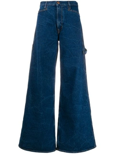 Shop Aries Flared Style Jeans In Blue
