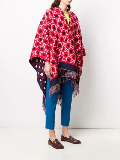 Shop Gucci Reversible Gg Fringed Poncho In Red