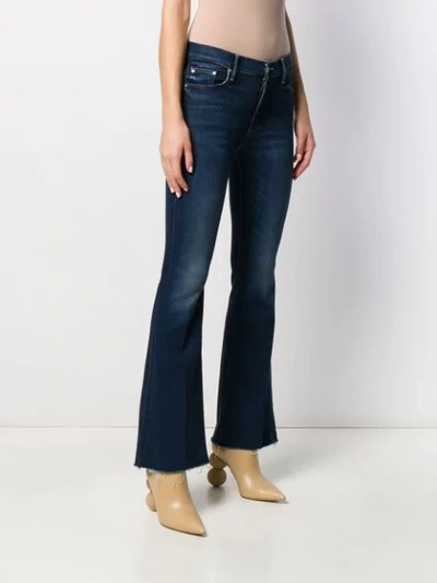 Shop Mother Low Rise Kick Flared Jeans In Blue